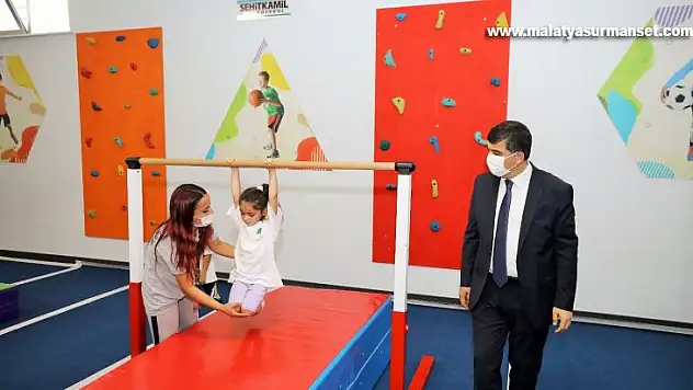 Anne ve babalar çocuklarıyla birlikte spor yapıyor